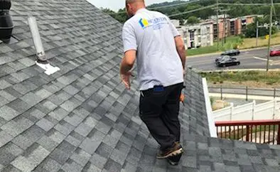Contractor inspecting the condition of a roof